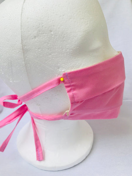 Pink pleated cotton face mask with tie back cords